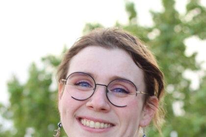 A photo of a woman smiling outside.