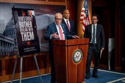 Minority Leader Chuck Schumer speaks at a press conference with Senators Cory Booker and Brian Schatz.