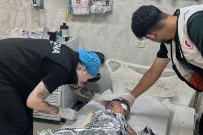 Andee Vaughan (L), with a child suffering from severe burns in July. Pic: Andee Vaughan/AP