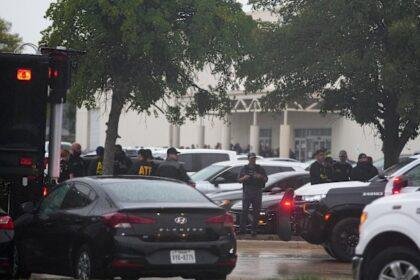Law enforcement gather at a staging area close to a US Immigration and Customs Enforcement office after the shooting.