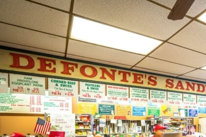 Customers ordering at the counter in Defonte's Sandwich Shop