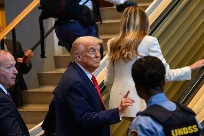 Donald Trump rides an escalator at the United Nations