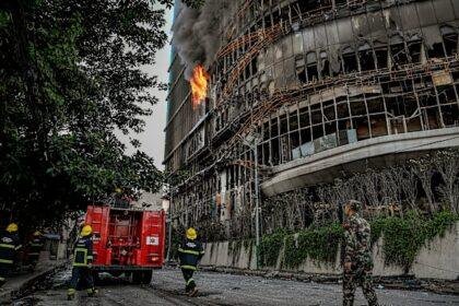 Nepali army personnel and firefighters outside the Hilton Kathmandu hotel after it was burned during days of riots and political upheaval.