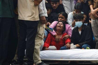 A mother of a protester killed in the demonstrations mourns next to his body. Pic: Reuters