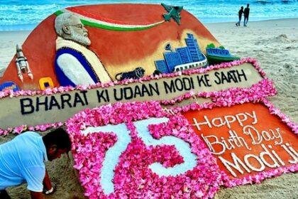 Sand artist Sudarsan Pattnaik makes a sculpture on the eve of Prime Minister Narendra Modi's 75th birthday on Puri beach, on Tuesday, (PTI)
