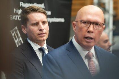 Andrew Hastie stands behind Peter Dutton.
