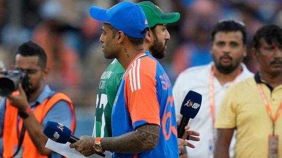 Pakistan's captain Salman Agha, rear, walks past India's captain Suryakumar Yadav after the coin toss ahead of the Asia Cup cricket match (AP)