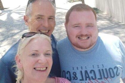 Victims Mark O'Connor and wife Louise O'Connor with son Evan O'Connor smile in a selfie taken in an outdoor space