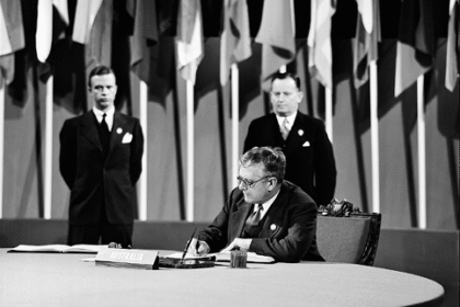 A 1945 black and white photo of Dr Herbert Vere Evatt sitting at a table in the UN