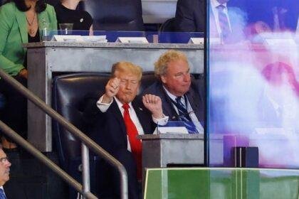 Donald Trump, in his signature suit and tie, was seated next to Yankees team president Randy Levine and chatted with him throughout the game.(AFP)