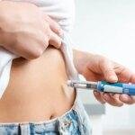 woman injecting weight loss drug in stomach