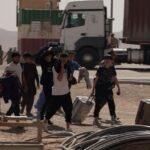 People cross the border with their belongings