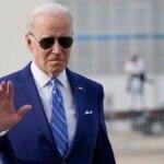 President Joe Biden waves as he walks to speaks to reporters before boarding Air Force One at Des Moines International Airport, in Des Moines Iowa, Tuesday, April 12, 2022, en route to Washington.