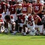 Oklahoma football players taking a knee
