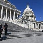 Police officers in front of the US Capitol Building.